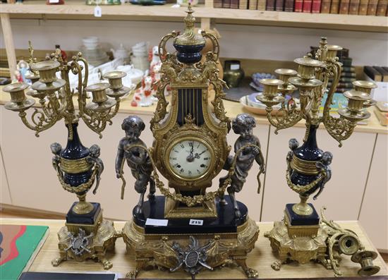 A 20th century gilt and putti clock garniture clock width 33cm height 62cm